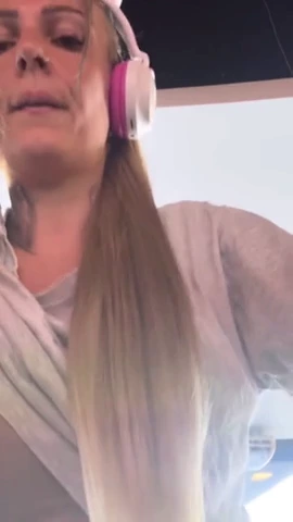 Busty white girl works out at the gym and experiences arousal, removing her t-shirt and bra to reveal her large breasts and wet pussy. porn video
